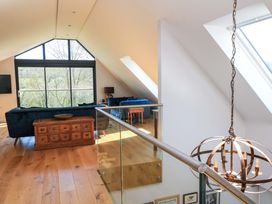 A living room with a sofa and coffee table at The Old Dairy in Cotleigh near Honiton