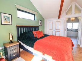 A bedroom with a bed and bedside table at The Old Dairy Cotleigh near Honiton