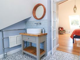 A bathroom with a sink and mirror at The Old Dairy Cotleigh near Honiton