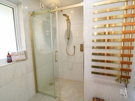 A bathroom with a shower and towels at The Old Dairy Cotleigh near Honiton