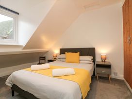 A bedroom with a bed and wardrobe at Saints Cottage in Scarborough