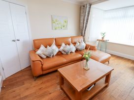A living room with a sofa and a coffee table at Beach Cove View in Newbiggin-by-the-Sea