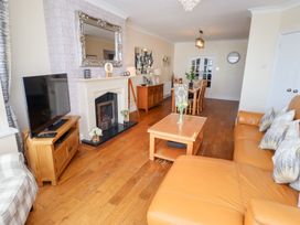 A living room with a television and coffee table at Beach Cove View in Newbiggin-by-the-Sea
