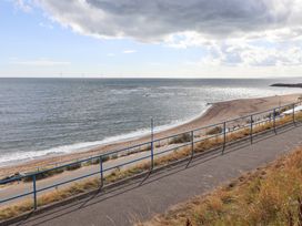 A view of the ocean and beach with a pathway at Beach Cove View in Newbiggin-by-the-Sea