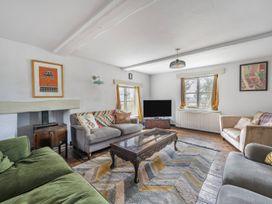 A living room with a coffee table and television at Spring Park Farmhouse Launceston