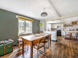 A kitchen with a dining table and chairs at Spring Park Farmhouse in Launceston