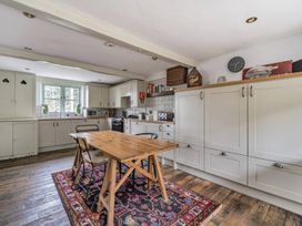 A kitchen with a table and chairs at Spring Park Farmhouse in Launceston
