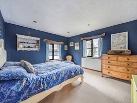 A bedroom with a bed and a shelf at Spring Park Farmhouse in Launceston