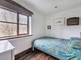 A bedroom with a bed and window at Spring Park Farmhouse in Launceston