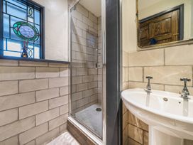 A bathroom with a shower and sink at Spring Park Farmhouse in Launceston