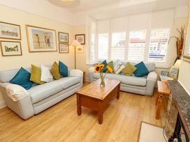 A living room with a coffee table and sofas at 32 Cranleigh Close Tuckton