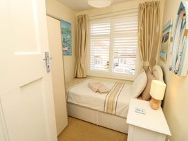 A bedroom with a single bed and nightstand at 32 Cranleigh Close Tuckton
