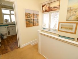 A hallway with a view of a bathroom at 32 Cranleigh Close Tuckton