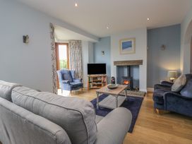 A living room with a television and fireplace at Langtree in Arnside