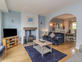 A living room with a tv and sofa at Langtree in Arnside