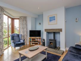 A living room with an armchair and fireplace at Langtree in Arnside