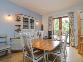 A dining room with a table and chairs at Langtree Arnside