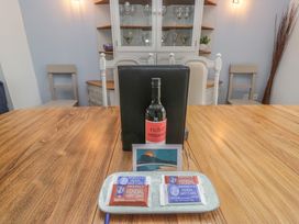 A dining room with wine, cake, and a menu at Langtree Arnside