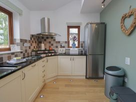 A kitchen with appliances and cabinets at Langtree Arnside