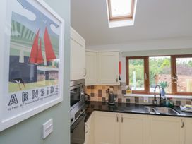 A kitchen featuring a sink and microwave at Langtree in Arnside