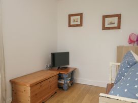 A living room with a television and furniture at Langtree in Arnside