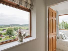 A bedroom with a view and a chicken figurine at Langtree Arnside