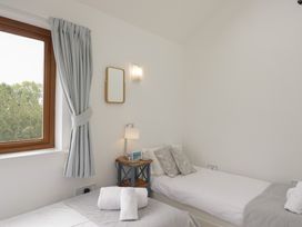 A bedroom with two beds and a window at Langtree in Arnside