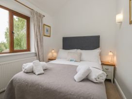 A bedroom with a bed and window at Langtree in Arnside