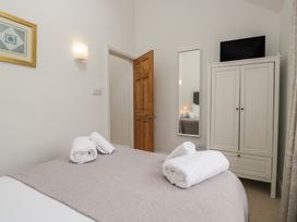 A bedroom with a bed and wardrobe at Langtree in Arnside