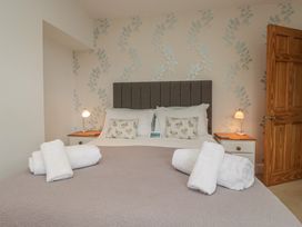 A bedroom with a bed and towels at Langtree in Arnside