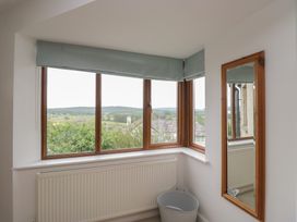 A room with a window and a mirror at Langtree in Arnside