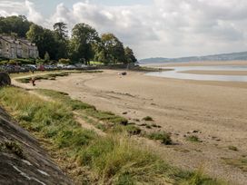 A beach scene with water and buildings at Langtree in Arnside