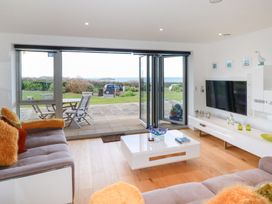 A living room with a sliding door open to a patio at Apartment no.21 in Newquay