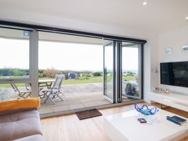 A living room with a glass door leading to a patio at Apartment no.21 in Newquay