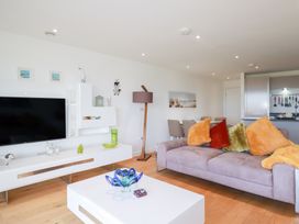 A living room with a television and sofa at Apartment no.21 in Newquay