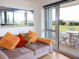 A living room featuring a sofa and window overlooking the garden at Apartment no.21 in Newquay