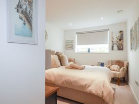 A bedroom with a bed and a chair at Apartment no.21 in Newquay