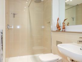 A bathroom with a shower, toilet, and sink at Apartment no.21 Newquay