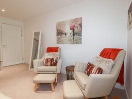 A living room with armchairs and a side table at Apartment no.21 in Newquay