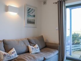 A living room with a sofa and wall art at 4 Ocean Reach, Bolberry