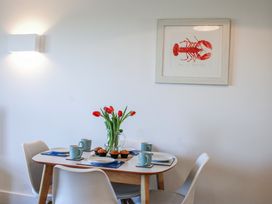 A dining table with cups and flowers at 4 Ocean Reach in Bolberry