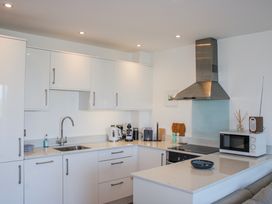 A kitchen with a sink, microwave, and coffee maker at 4 Ocean Reach in Bolberry