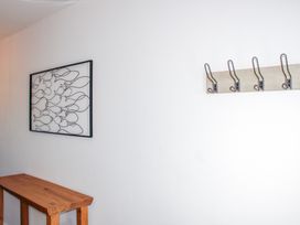 A hallway with wall art and coat hooks at 4 Ocean Reach, Bolberry