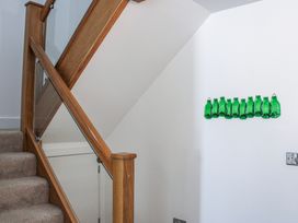 A staircase with glass bottles on the wall at 4 Ocean Reach in Bolberry