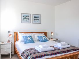 A bedroom with a bed and side tables at 4 Ocean Reach Bolberry
