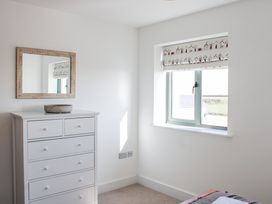 A bedroom with a chest of drawers and a window at 4 Ocean Reach in Bolberry