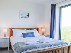 A bedroom with a bed and bedside tables at 4 Ocean Reach in Bolberry