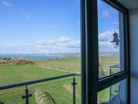 A view from a window showing grass and sea at 4 Ocean Reach Bolberry