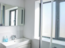 A bathroom with a sink and mirror at 4 Ocean Reach in Bolberry