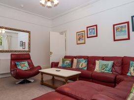 A living room with a sofa and armchair at Babbacombe Hall in Babbacombe